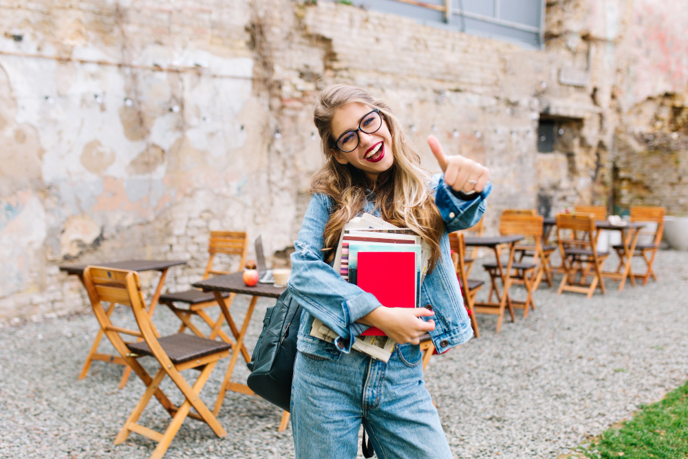 stylish hipster girl retro jeans suit posing front old brick wall trendy young woman with bag standing old building